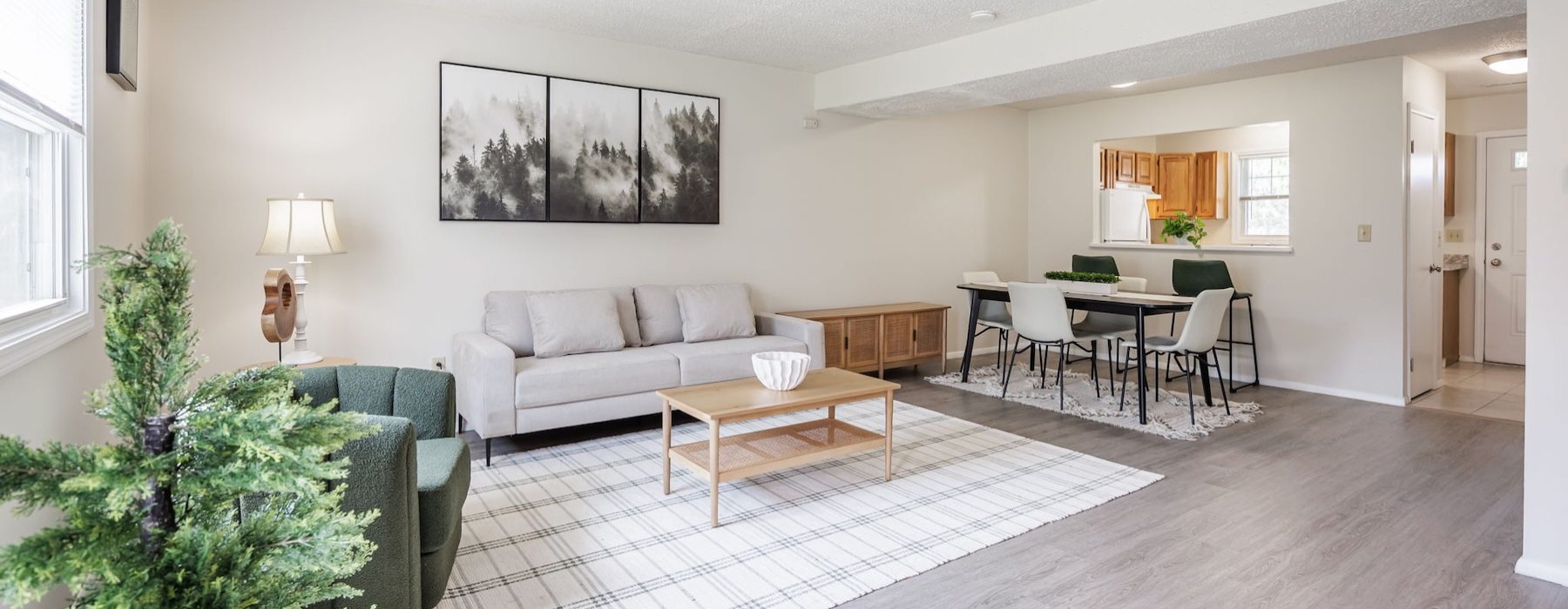 a living room with a couch, tables and chairs