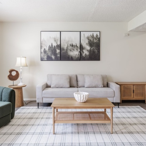 a living room with a couch, tables and chairs