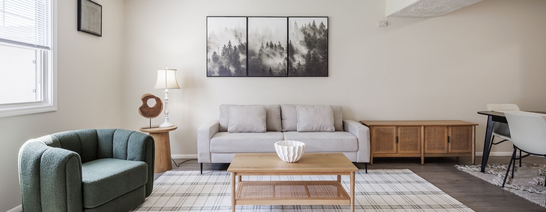 a living room with a couch, tables and chairs