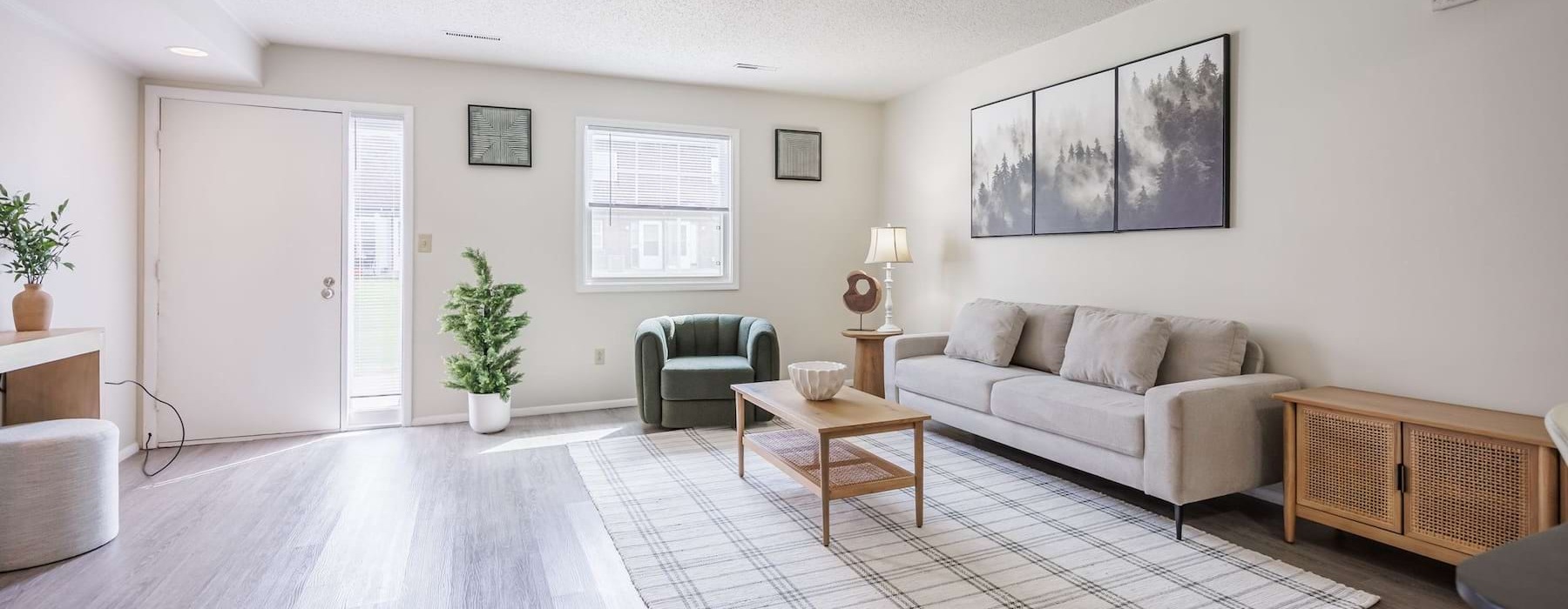 a living room with a couch, tables and chairs