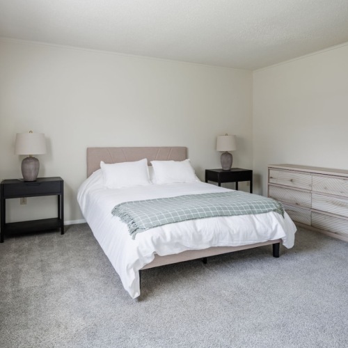 a bedroom with a bed and two nightstands