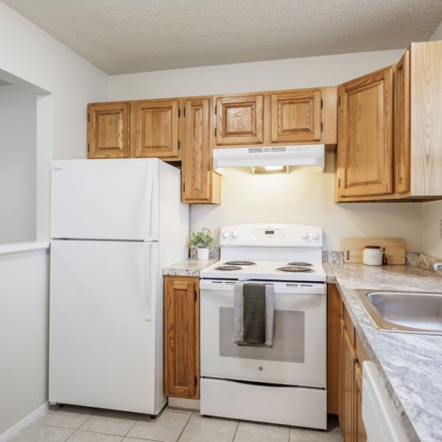 a kitchen with wood cabinets