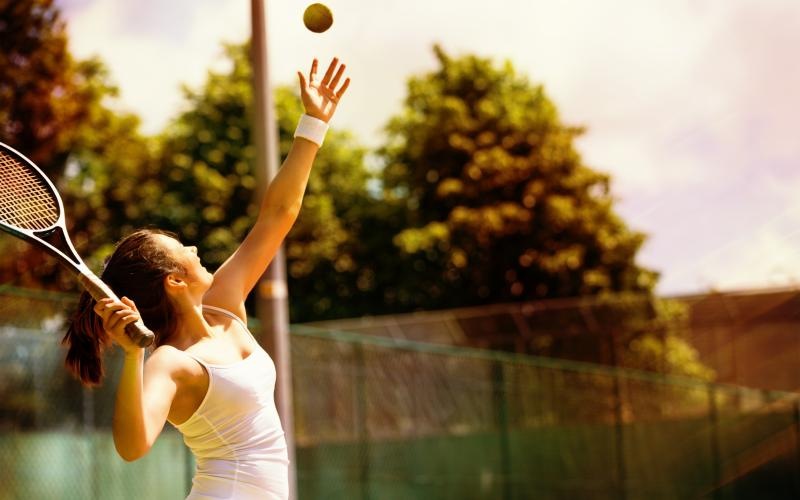 a person hitting a ball with the tennis racket