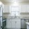 a kitchen with white cabinets