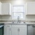 a kitchen with white cabinets