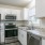 a kitchen with white cabinets