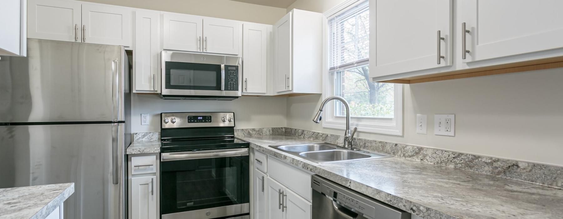 a kitchen with white cabinets