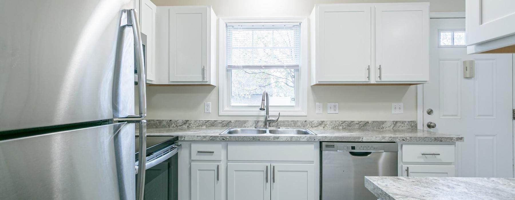 a kitchen with white cabinets