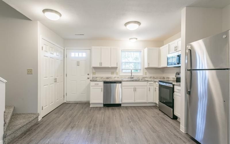 a kitchen with white cabinets